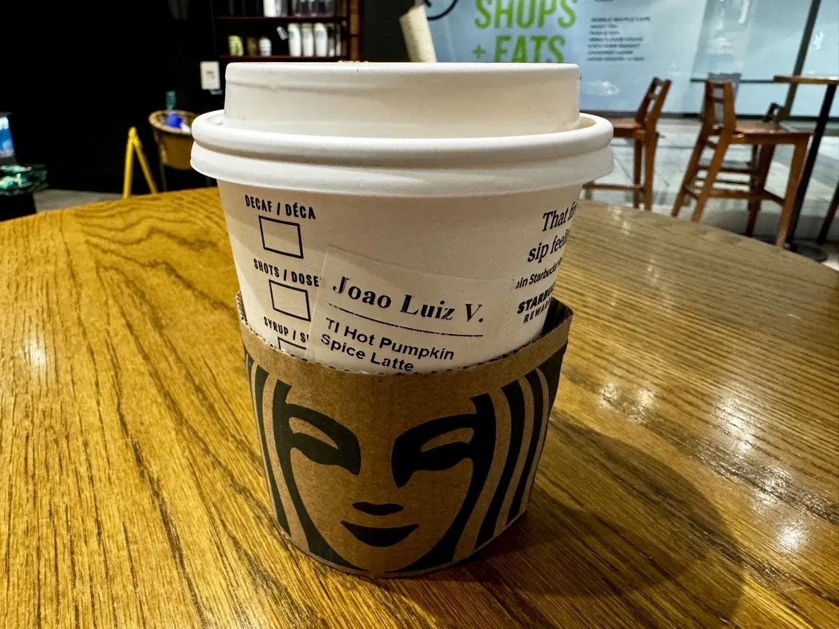 Starbucks cup with a label reading Joao Luiz V. for a hot pumpkin spice latte